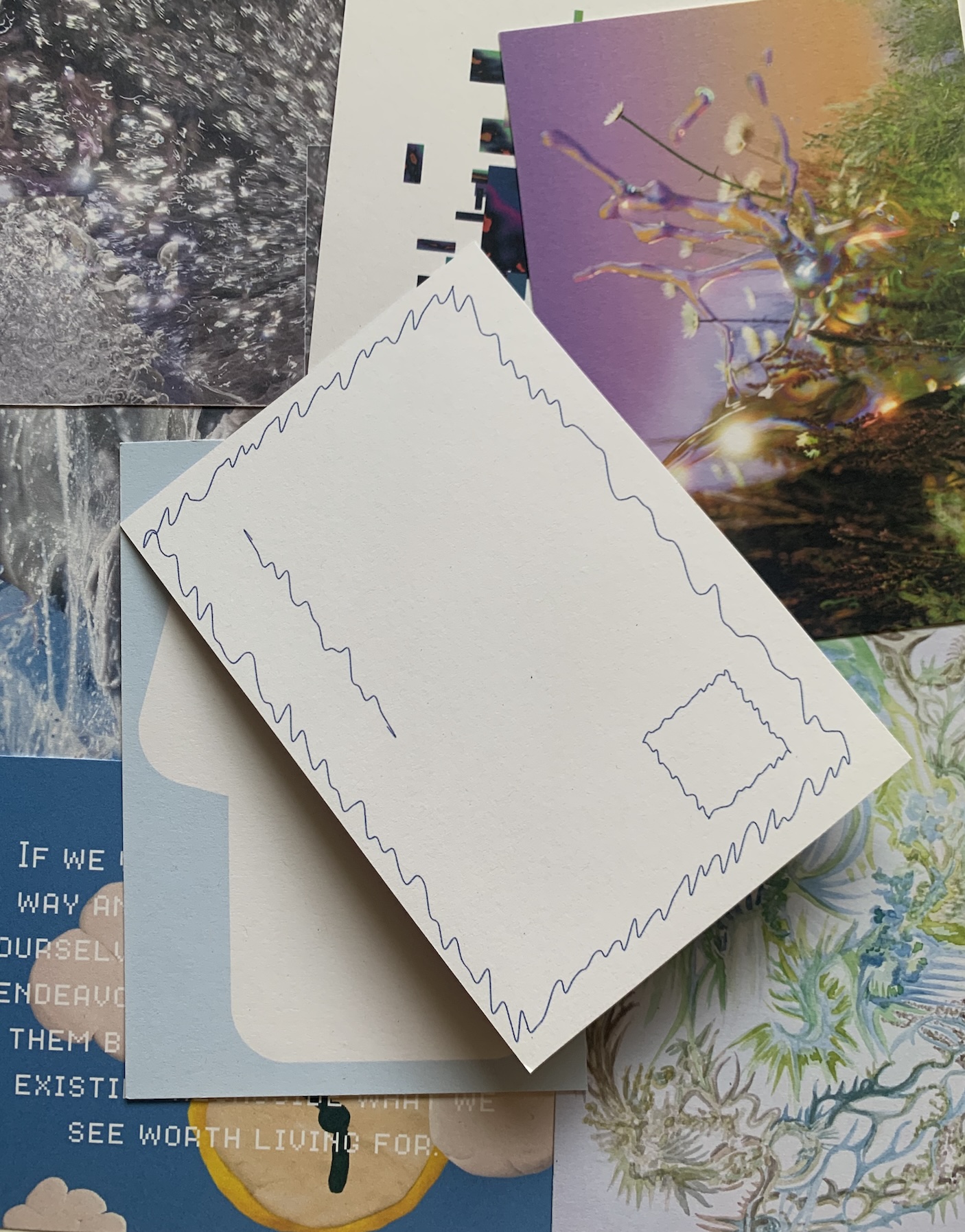Postcards laying in a pseudo random arrangement with the top one showing the backside